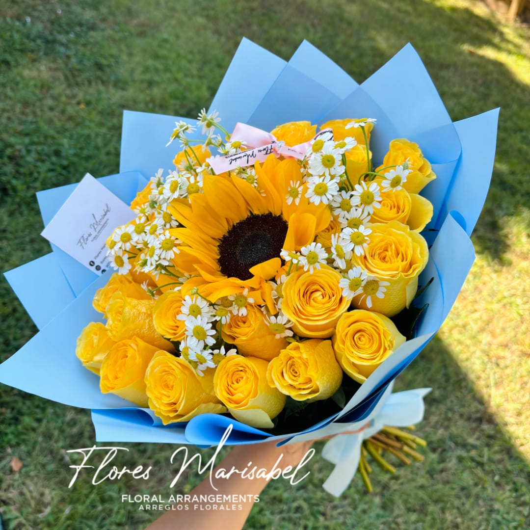 Yellow roses and a sunflower bouquet wrapped in blue paper