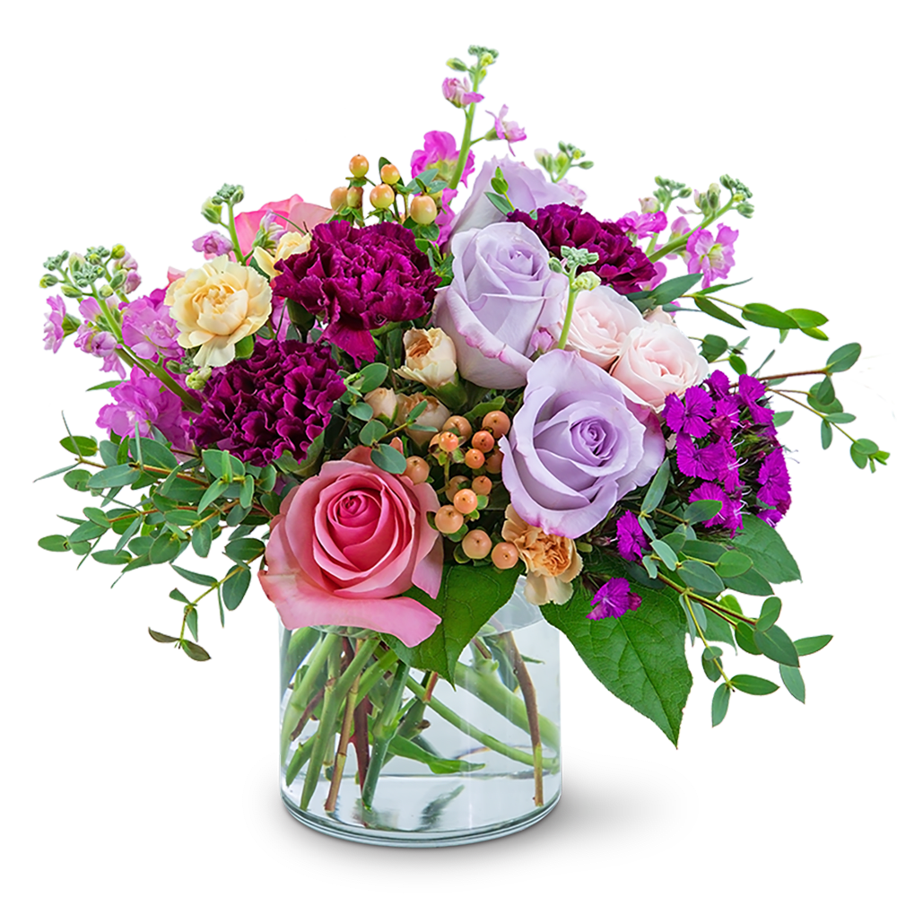 Mixed bouquet of pink, lavender, and purple roses in a glass vase