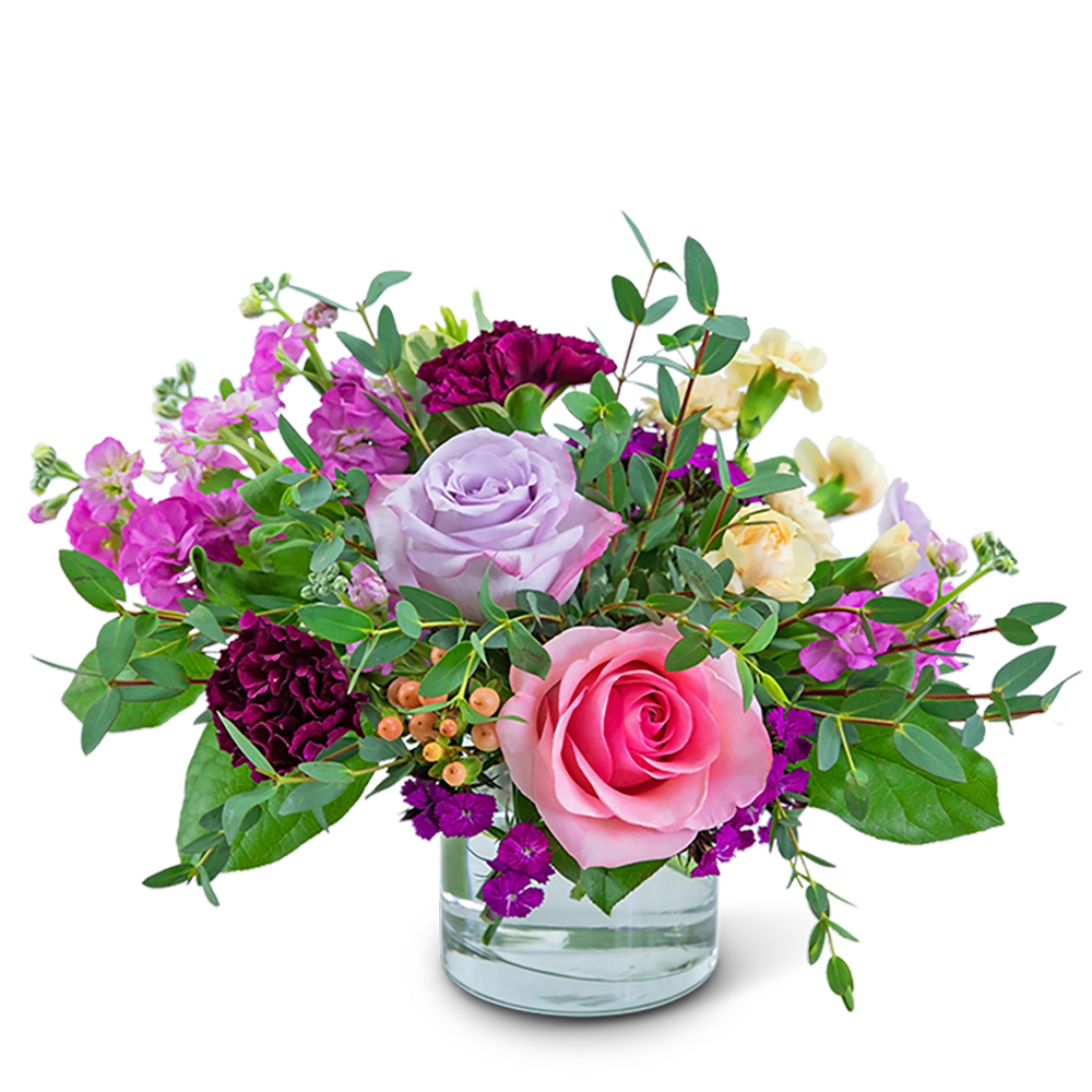 Pink and lavender roses in a clear glass vase