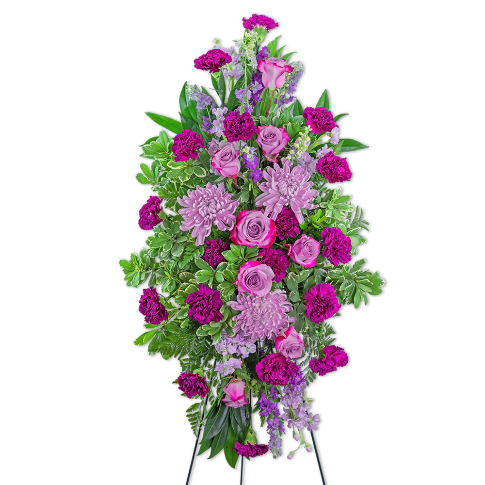 Tall standing spray of pink and purple flowers on a black easel