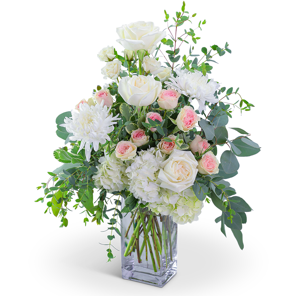 White roses and chrysanthemums in a clear glass vase