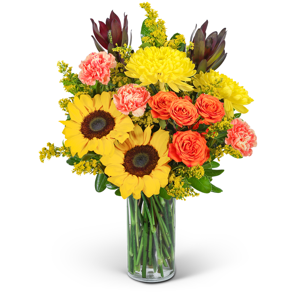 Bouquet of sunflowers, orange roses, and pink carnations in a glass vase