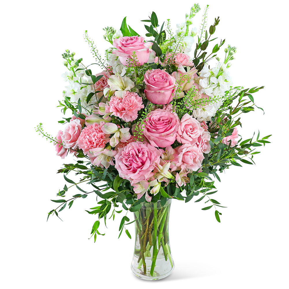 Pink roses and carnations in a clear glass vase