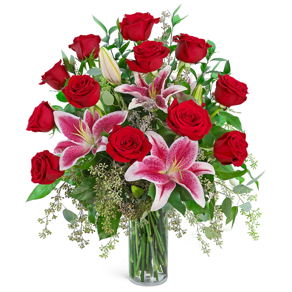 Red roses and pink lilies in a clear glass vase