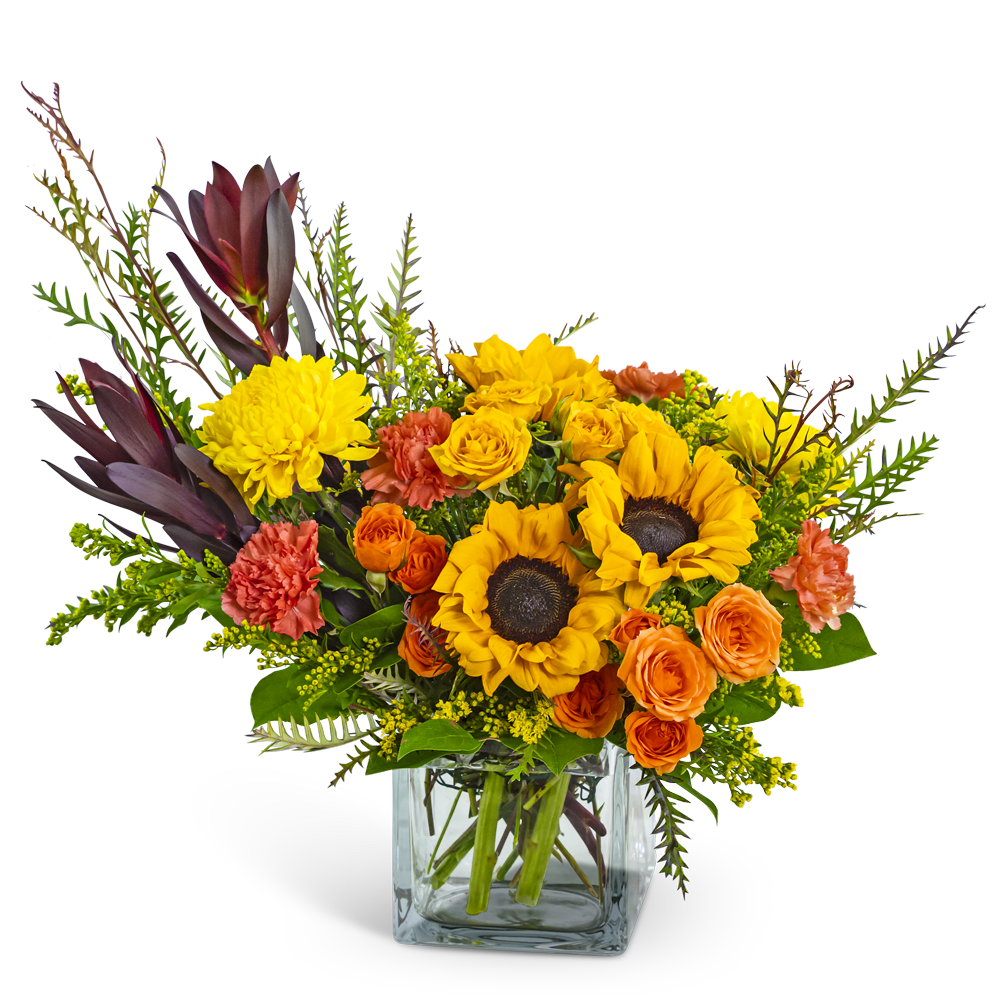 Sunflowers and orange roses in a clear glass vase