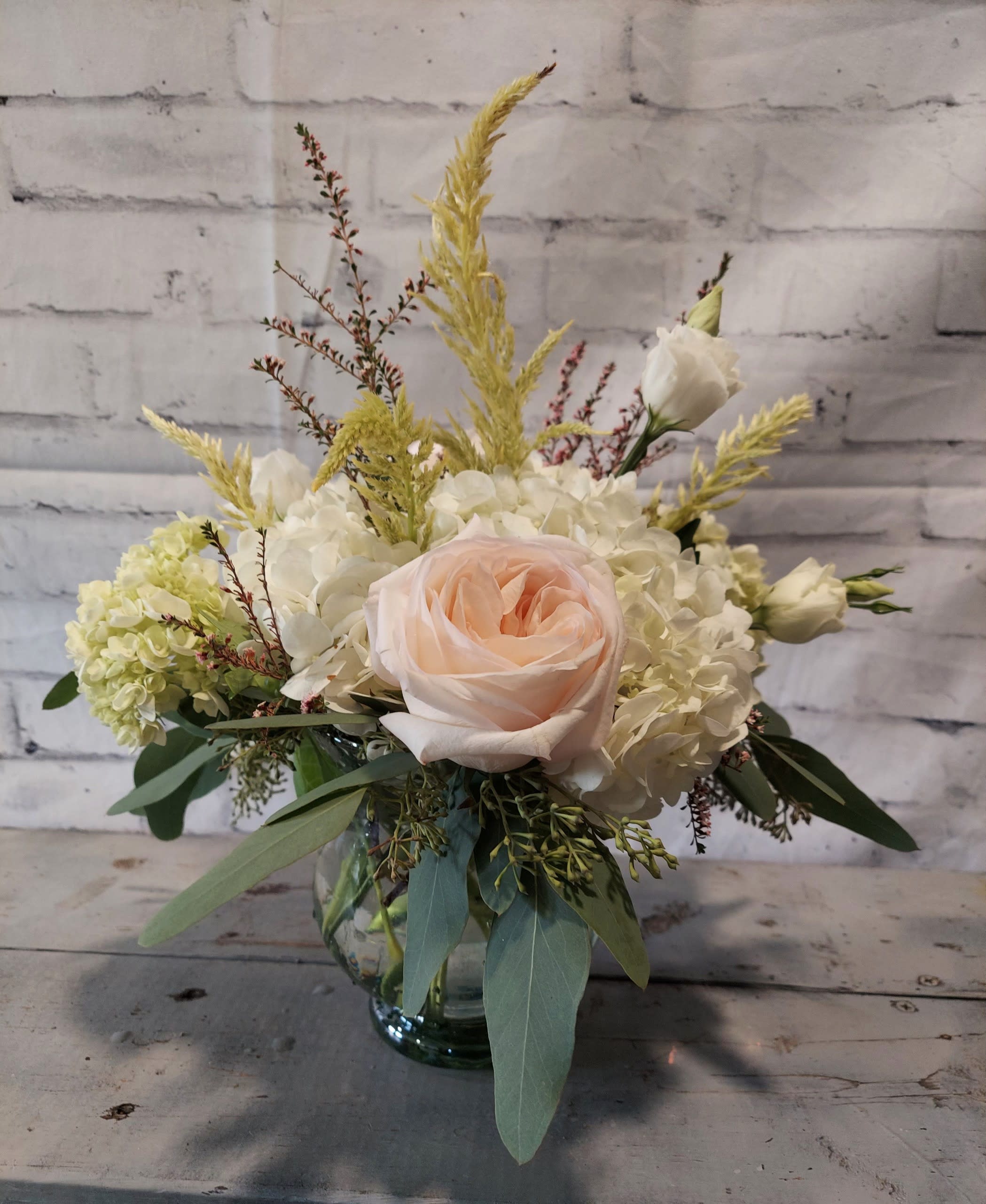 Blush rose and white hydrangea arrangement in a glass vase