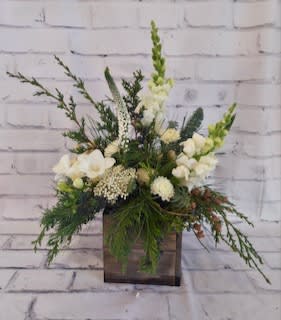 White floral arrangement in a square wooden container