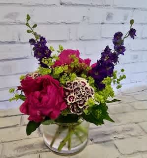Pink and purple mixed bouquet in a clear glass vase