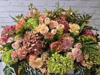 Large mixed bouquet with pink, peach, and green flowers