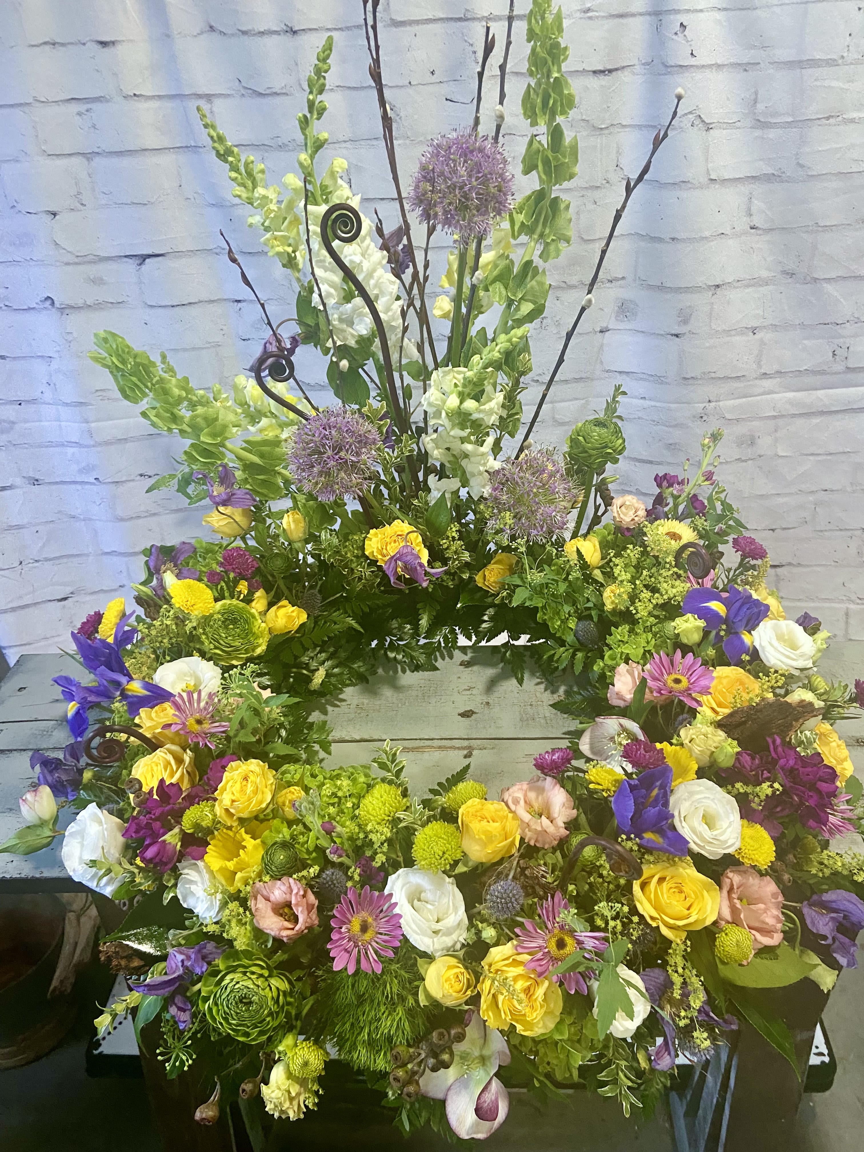 Eternal Life Urn Wreath - Celebrate a remarkable life with this magnificent display of  roses, lisianthus, daisies, and succulents to adorn an urn or picture frame.