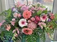 Mixed pink and purple flower arrangement in a vase