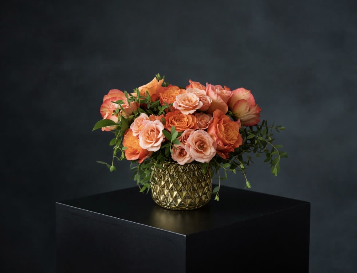 Jackson Sunrise  - Ten gorgeous garden roses with elegant greenery and peachy spray roses all designed in a gold geometric vase. 