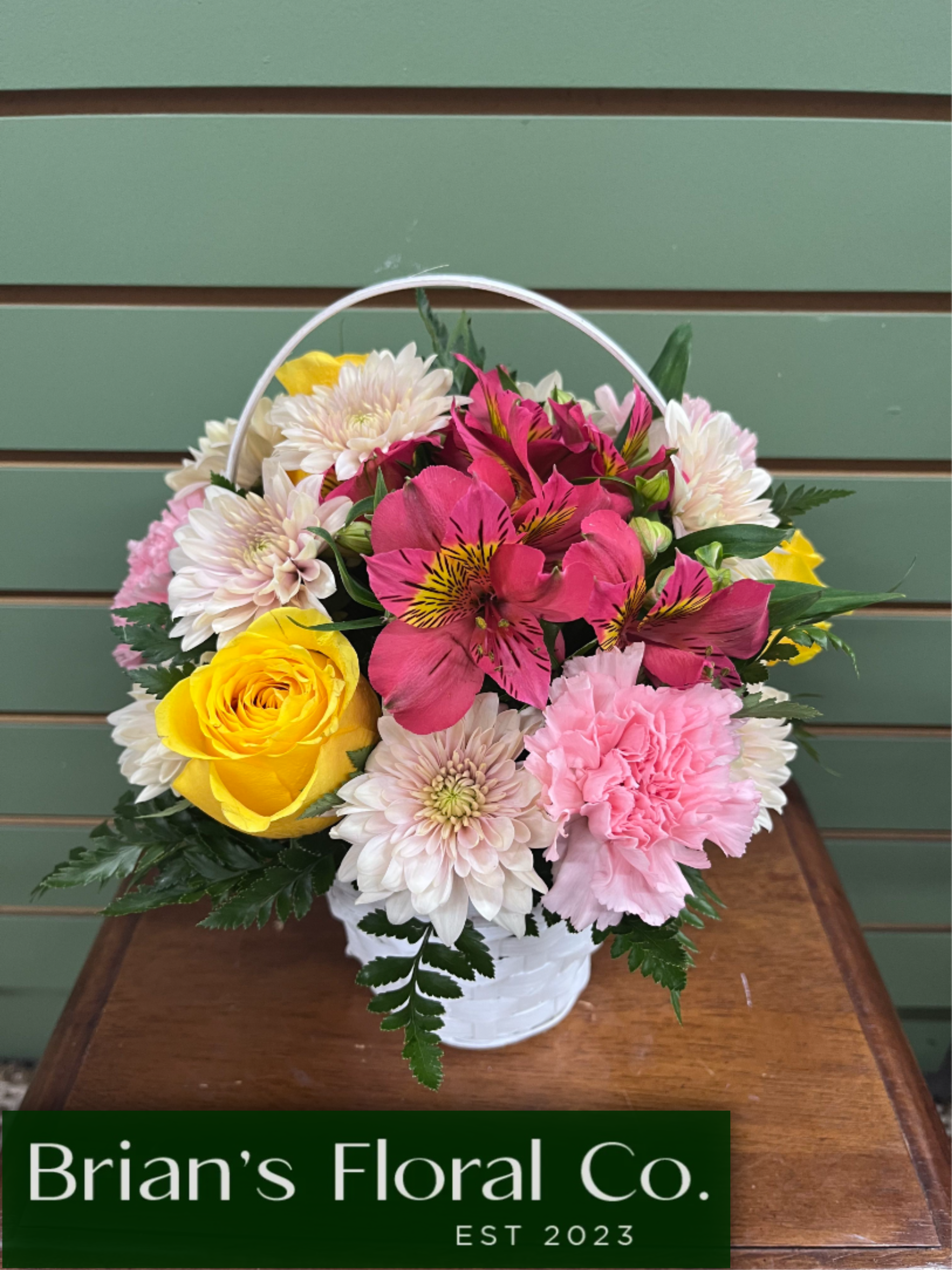 Day Brightener Basket by Brian's Floral - Make their day, by sending this beautiful bouquet. Day Brightener Basket by Brian's Floral features bright yellow roses, pretty pink carnations, alstroemeria and mums in a quaint basket. Bringing cheer to a birthday, office space, or our favorite reason Just Because! Standard Size is aprox 12"x12"