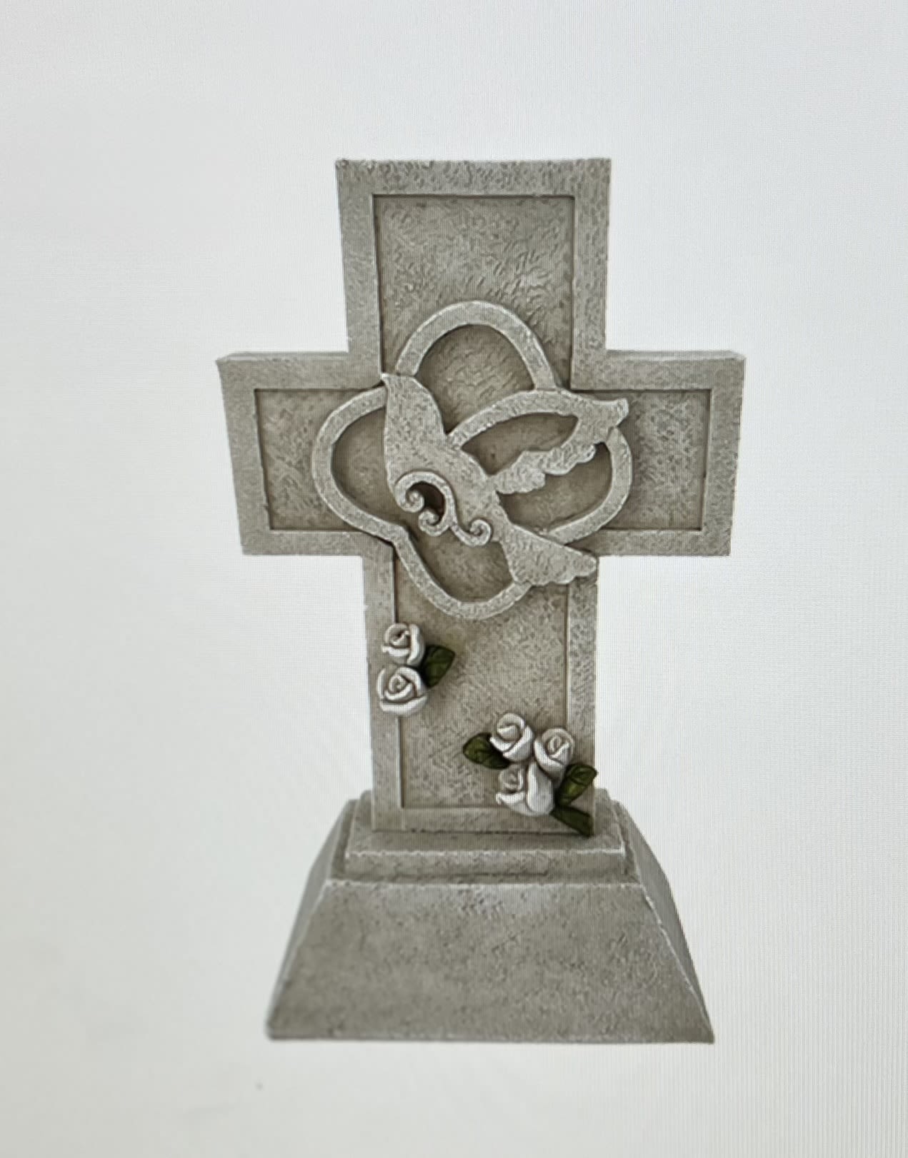 Decorative stone cross with small white roses and green leaves