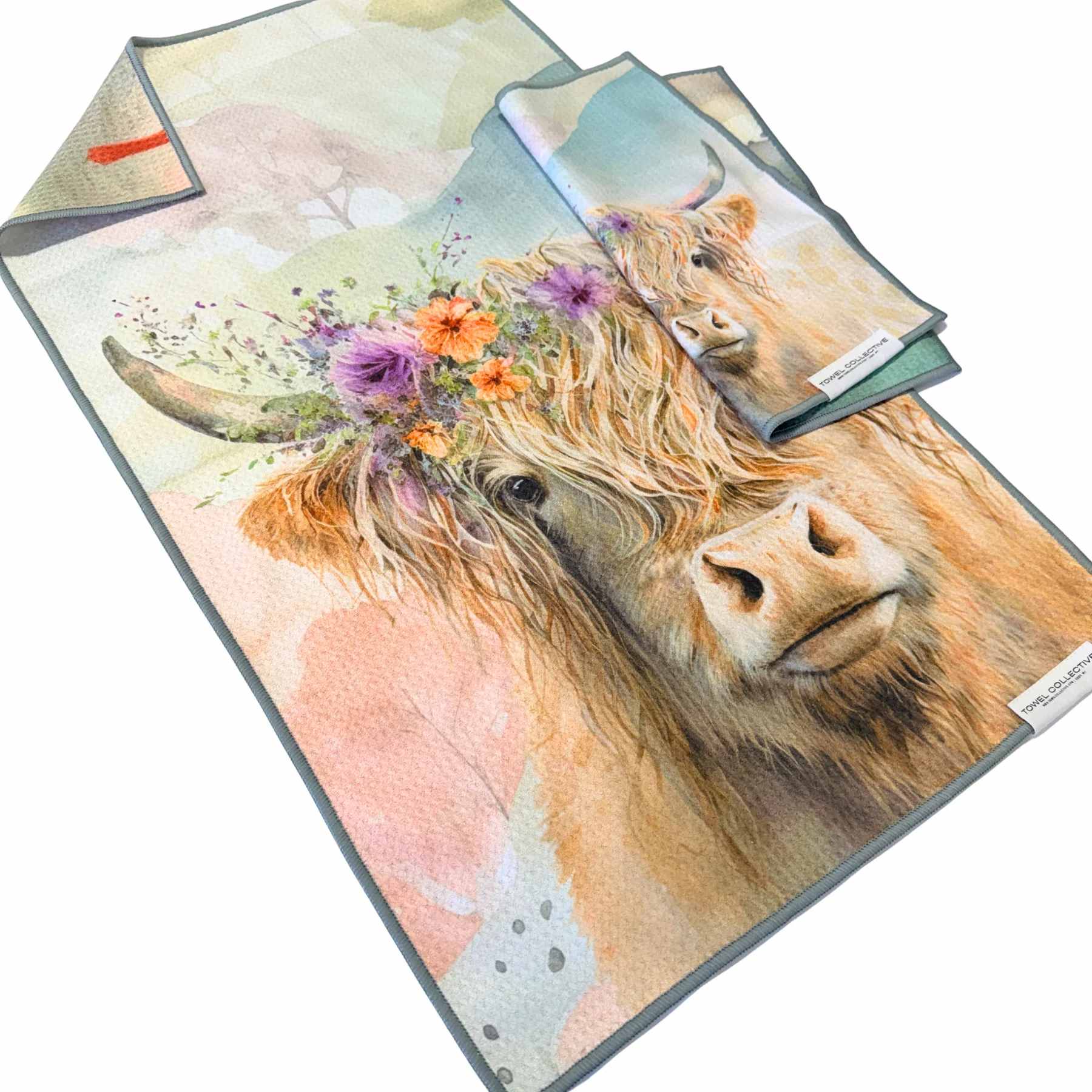 Folded towels with a cow print and floral accents