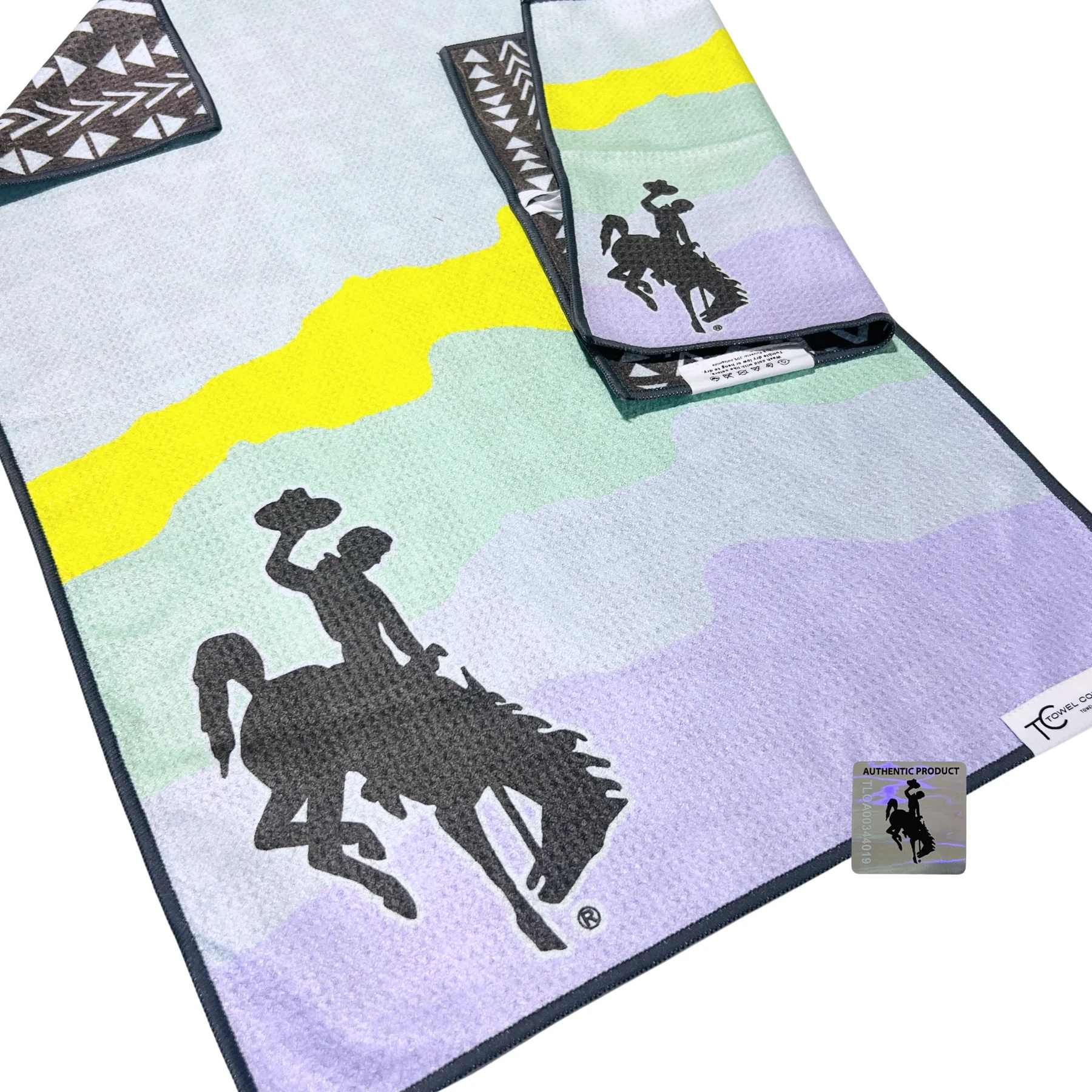 Pastel striped towel with black horse-and-rider silhouettes