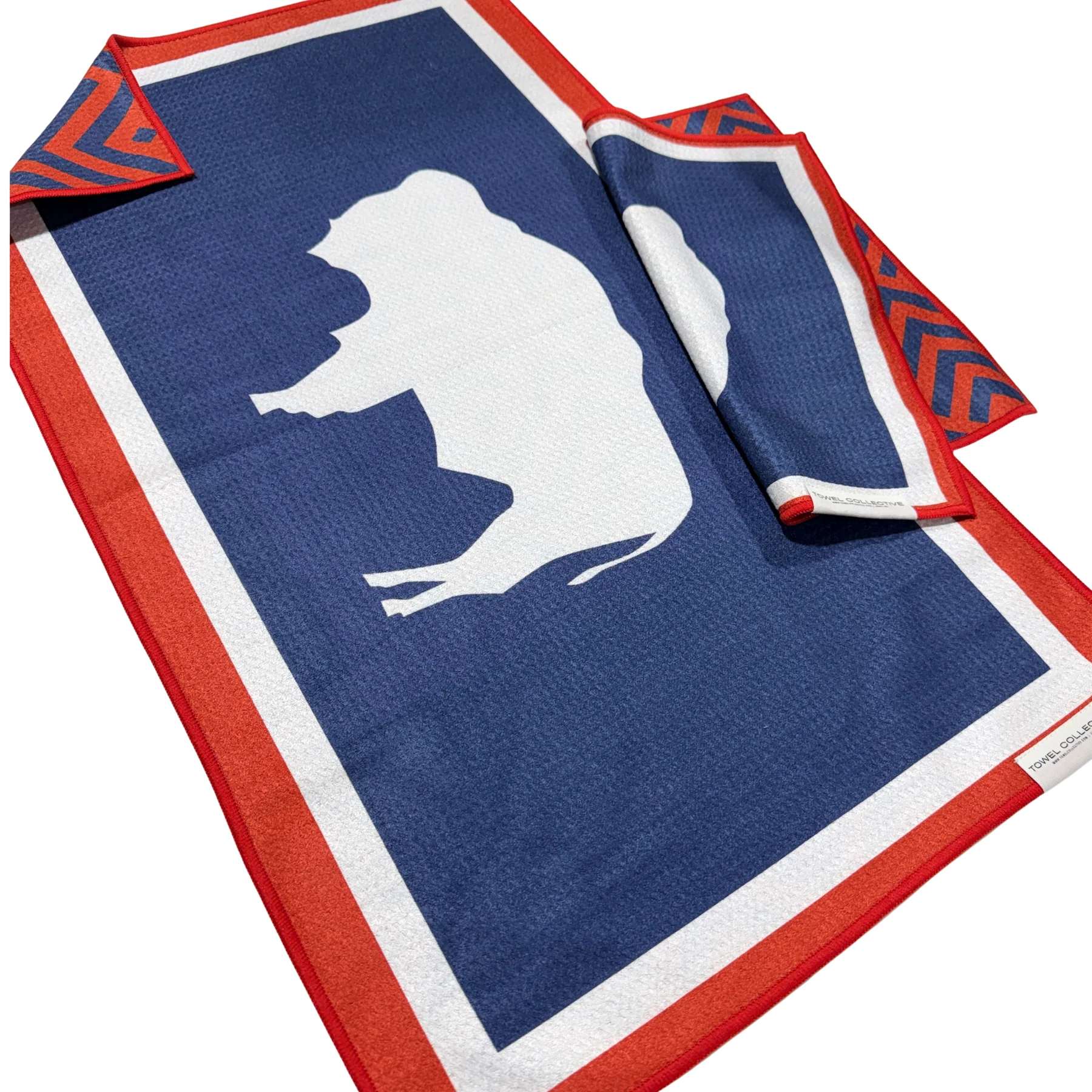 Blue and red towel with a white animal silhouette and folded corner