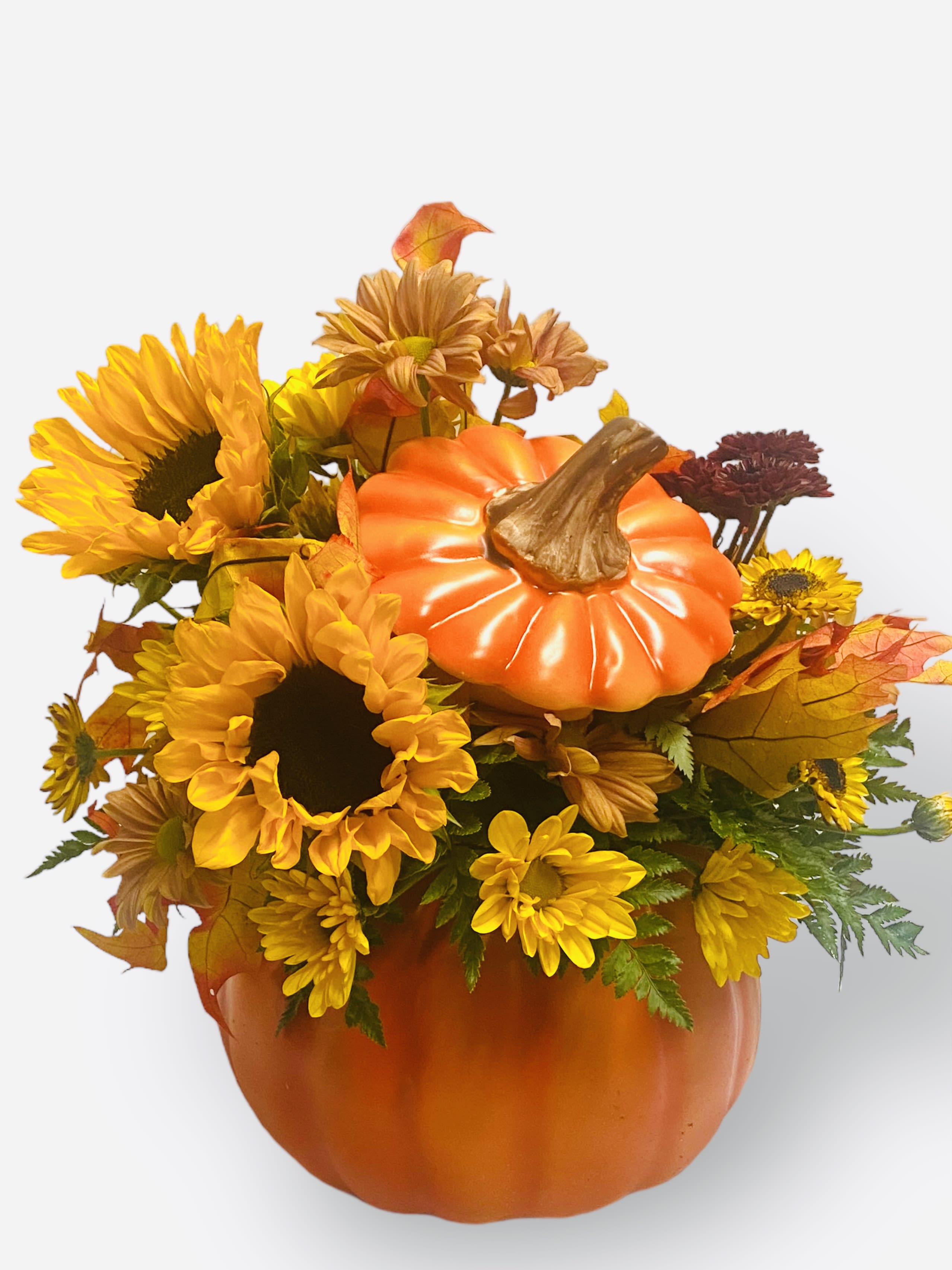 Pumpkin-shaped floral arrangement with sunflowers and autumn mums in an orange container