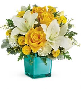 Golden Laughter Bouquet - Inspired by the sunny sound of children's laughter, this lighthearted bouquet of golden roses and fragrant white lilies is presented in a stunning aqua cube vase. What a stylish way to make someone smile!  This cheerful bouquet features yellow roses, white Asiatic lilies, white carnations, yellow button spray chrysanthemums, seeded eucalyptus, dusty miller and leatherleaf fern. Delivered in a glass cube.  Orientation: One-Sided