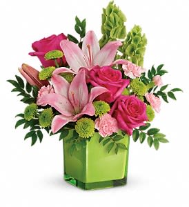 In Love With Lime Bouquet - Lime-a-licious! Fresh shades of green are a great way to contrast pink roses and lilies. Hand-delivered in a lovely leaf green cube, it's a loving gift any day of the week! This refreshing arrangement features hot pink roses, pink Asiatic lilies, pink miniature carnations, bells of Ireland, green button spray chrysanthemums, and huckleberry. Delivered in a lime green glass cube.  Orientation: One-Sided