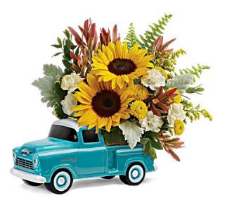 Sunflower arrangement in a turquoise toy truck