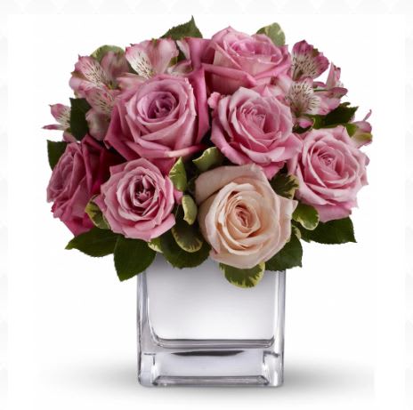 Pink rose bouquet in a clear square vase
