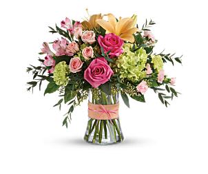 Bouquet of pink and yellow flowers in a glass vase