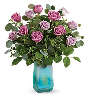 Pink and lavender roses in a blue glass vase