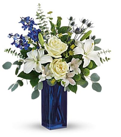 Calming Cobalt Bouquet  - With its deep cobalt glass vase and pure white blooms, this soothing bouquet is a stylish gesture for any special occasion! This arrangement includes white roses, white asiatic lilies, white alstroemeria, blue delphinium, green button spray chrysanthemums, blue eryngium, bupleurum, spiral eucalyptus, silver dollar eucalyptus, and lemon leaf. Available for same day delivery to most Denver locations!   