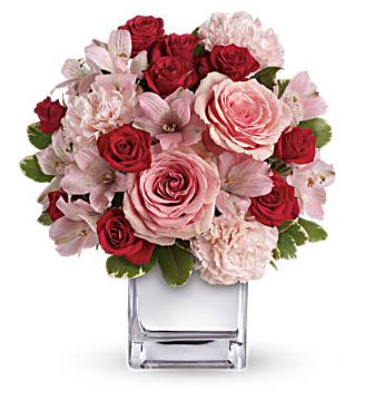 Pink and red rose bouquet in a clear square vase