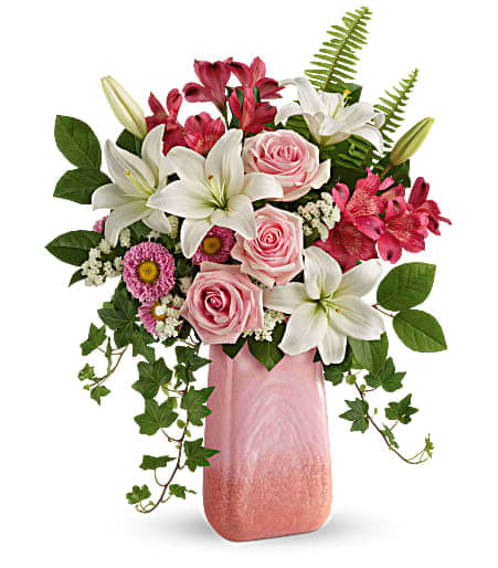 Pink roses and white lilies in a pink vase