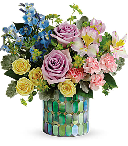 Mixed bouquet of roses and lilies in a mosaic vase