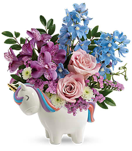 Pink and blue flowers arranged in a unicorn-shaped vase