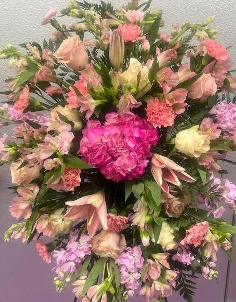 Large pink and pastel mixed flower arrangement with lilies and carnations
