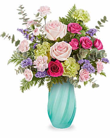 Pink and white roses in a turquoise vase