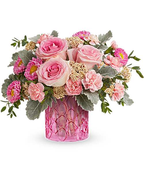 Pink roses and carnations in a pink glass vase