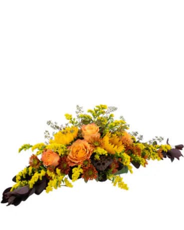 Orange roses and yellow flowers arranged in a low centerpiece