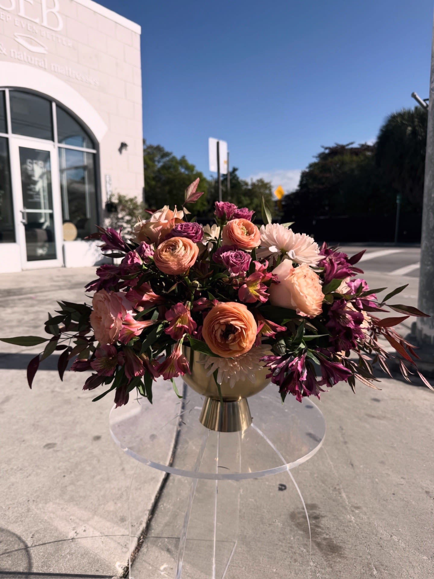 This Is a Statement - Peach roses and blush florals meet deep magenta accents in this lush, garden-inspired centerpiece.