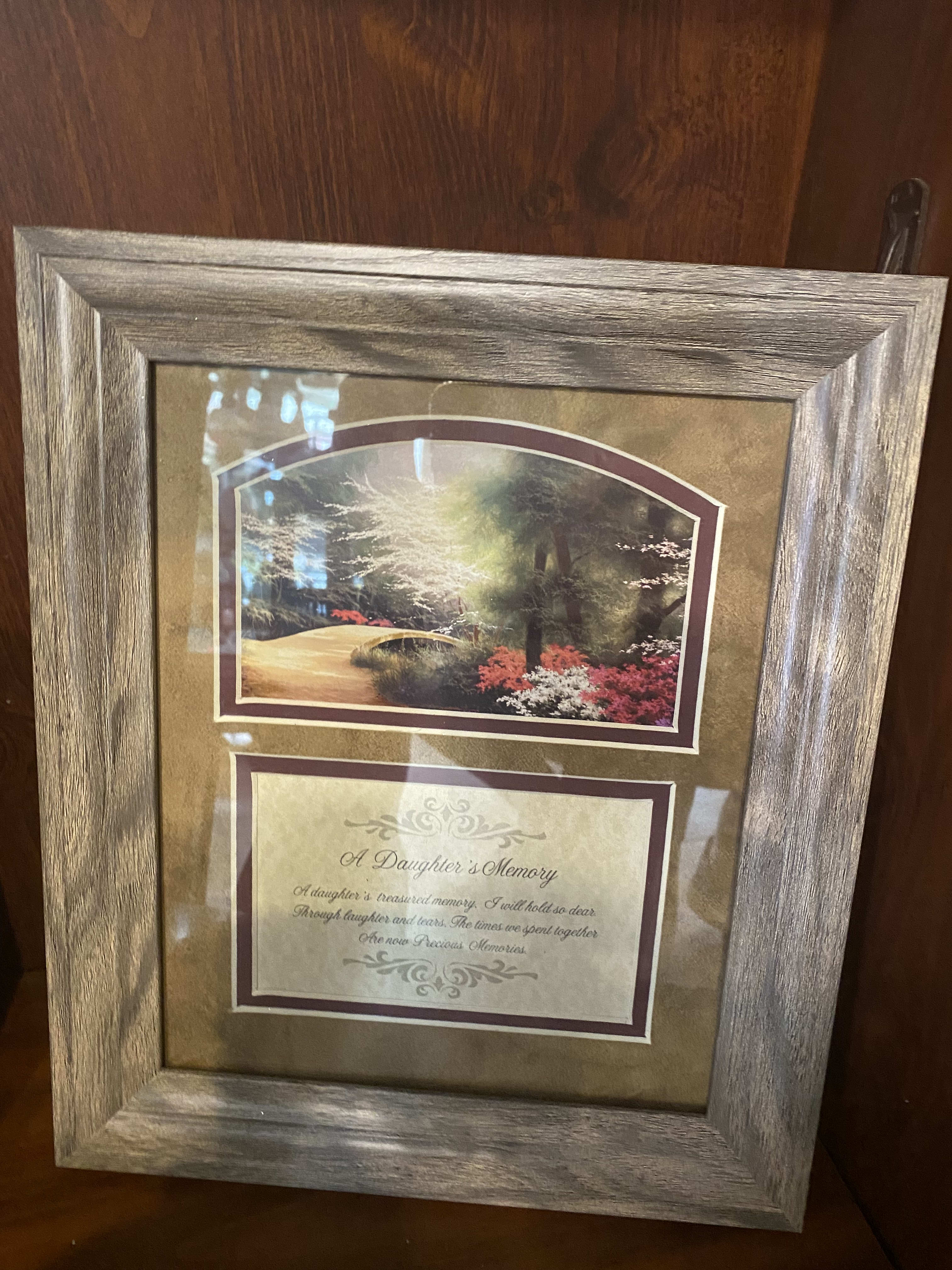 Framed memorial plaque with a landscape scene and sympathy verse