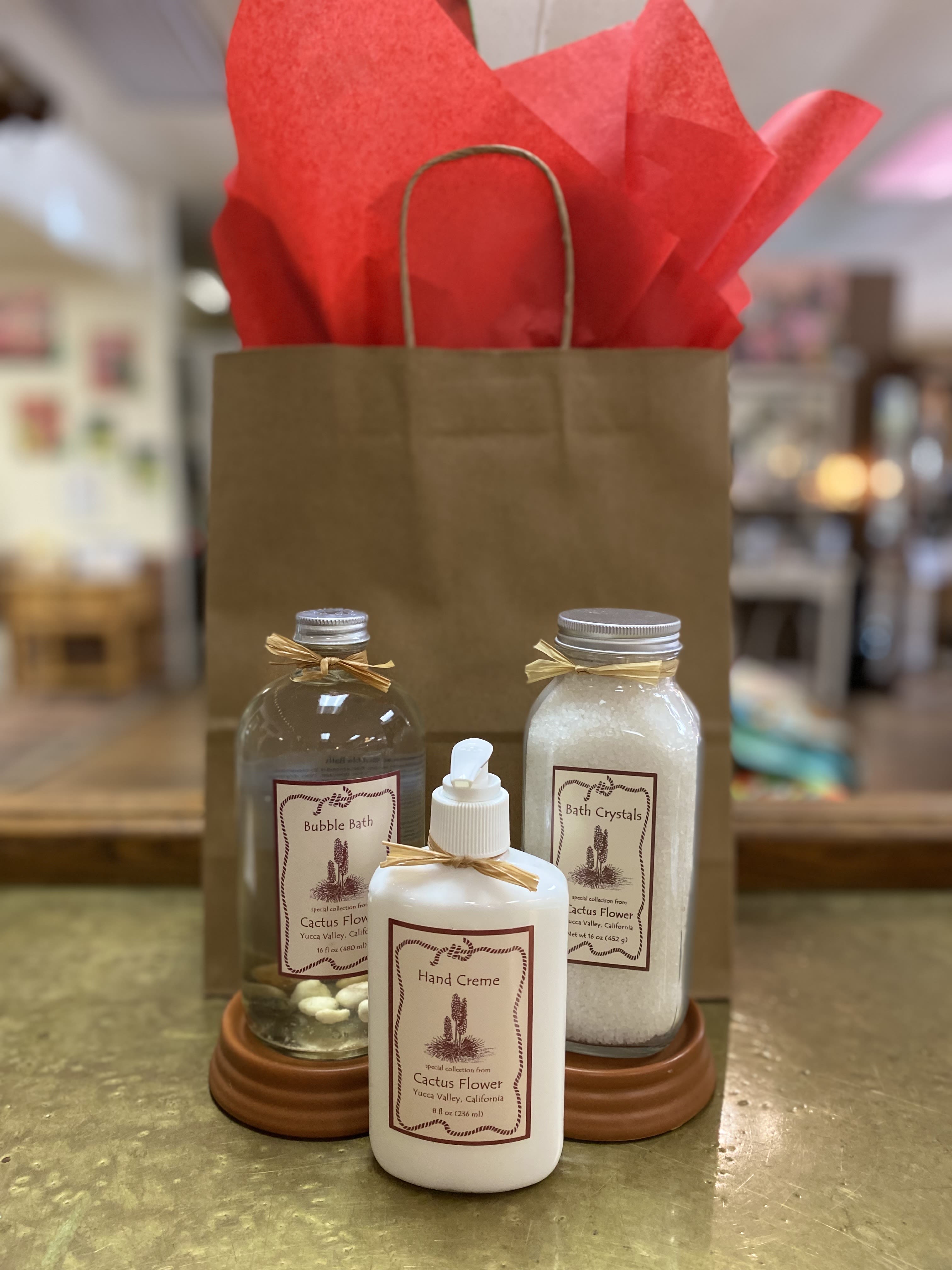 Gift bag with bath products and red tissue paper