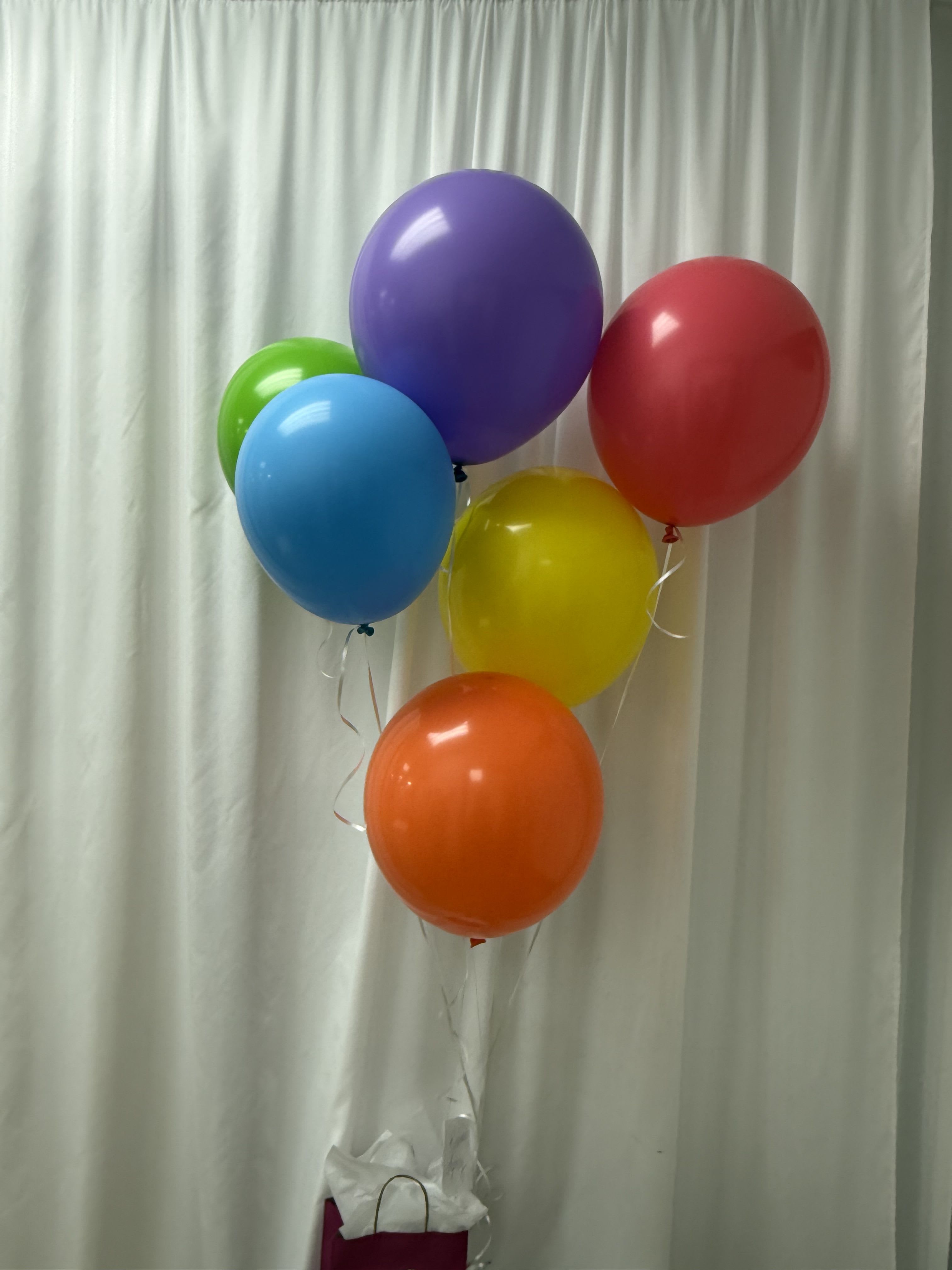 Bright Helium Balloon Cluster - 6 bright, glossy balloons filled with helium and tied onto a balloon weight.  Perfect for any celebration!
