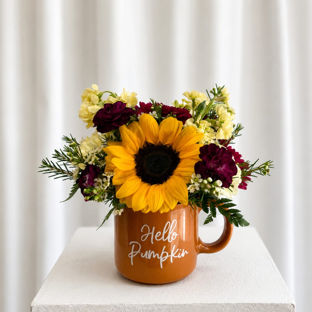 Sunflower arrangement in an orange mug with "Hello Pumpkin" text