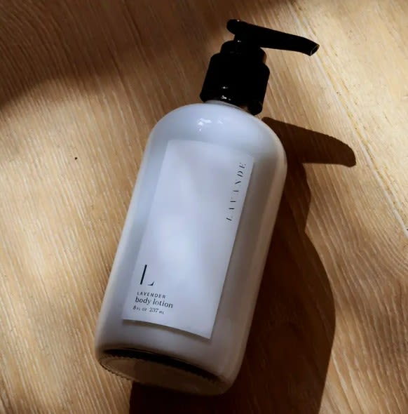 Bottle of lavender body lotion on a wooden surface