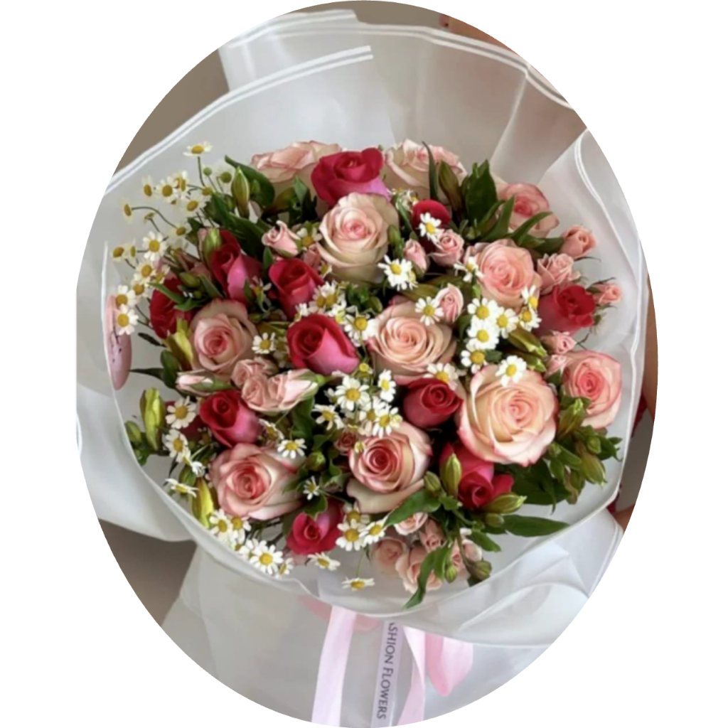 Bouquet of pink and red roses with small white daisies wrapped in white paper