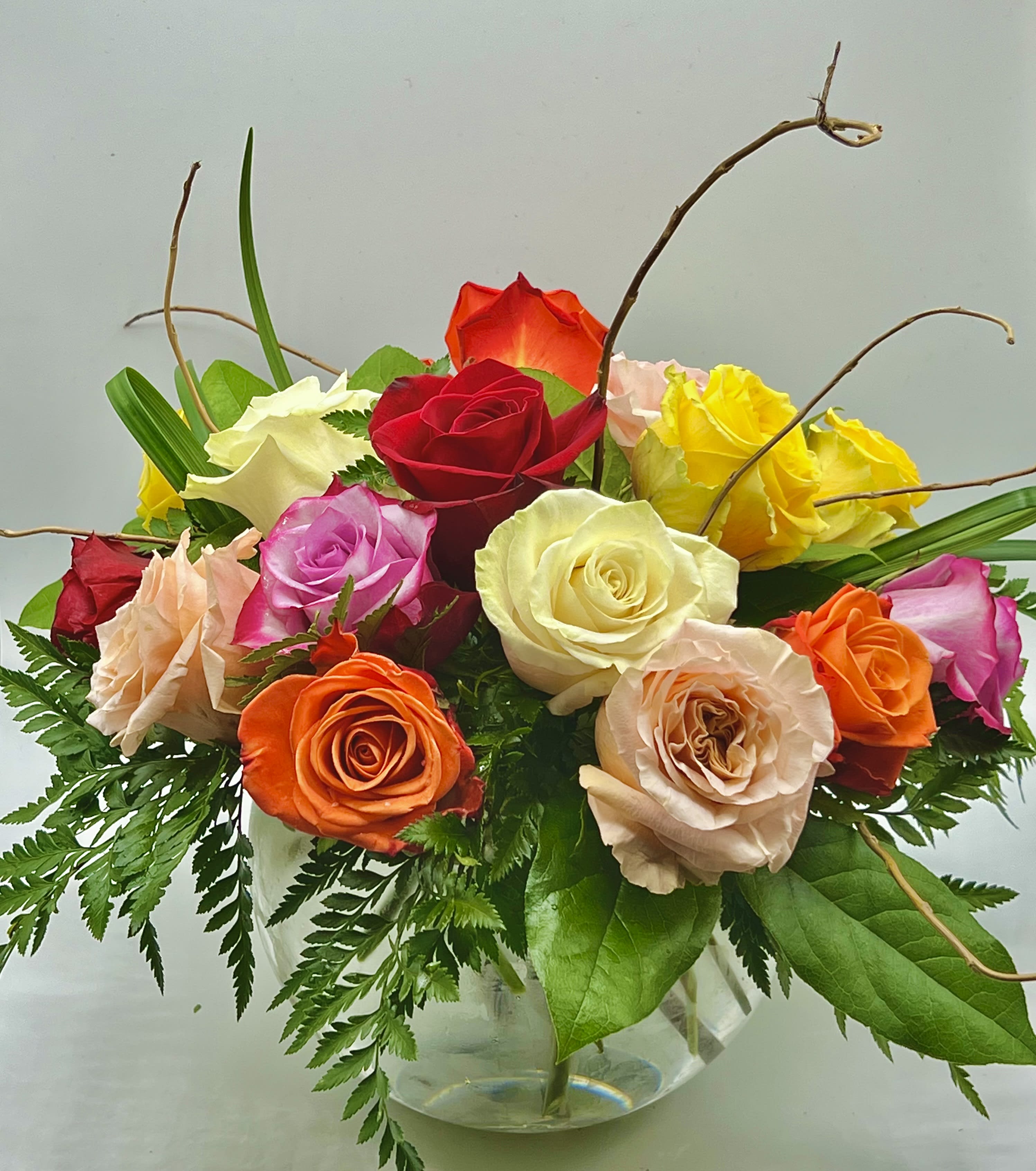 Love You! - Our Top Seller! A Spectacular Round Vase Arrangement of 18 Assorted Color Roses. Our Favorite Centerpiece, by Far! Sure to Feel the Love when this Arrives at your door!