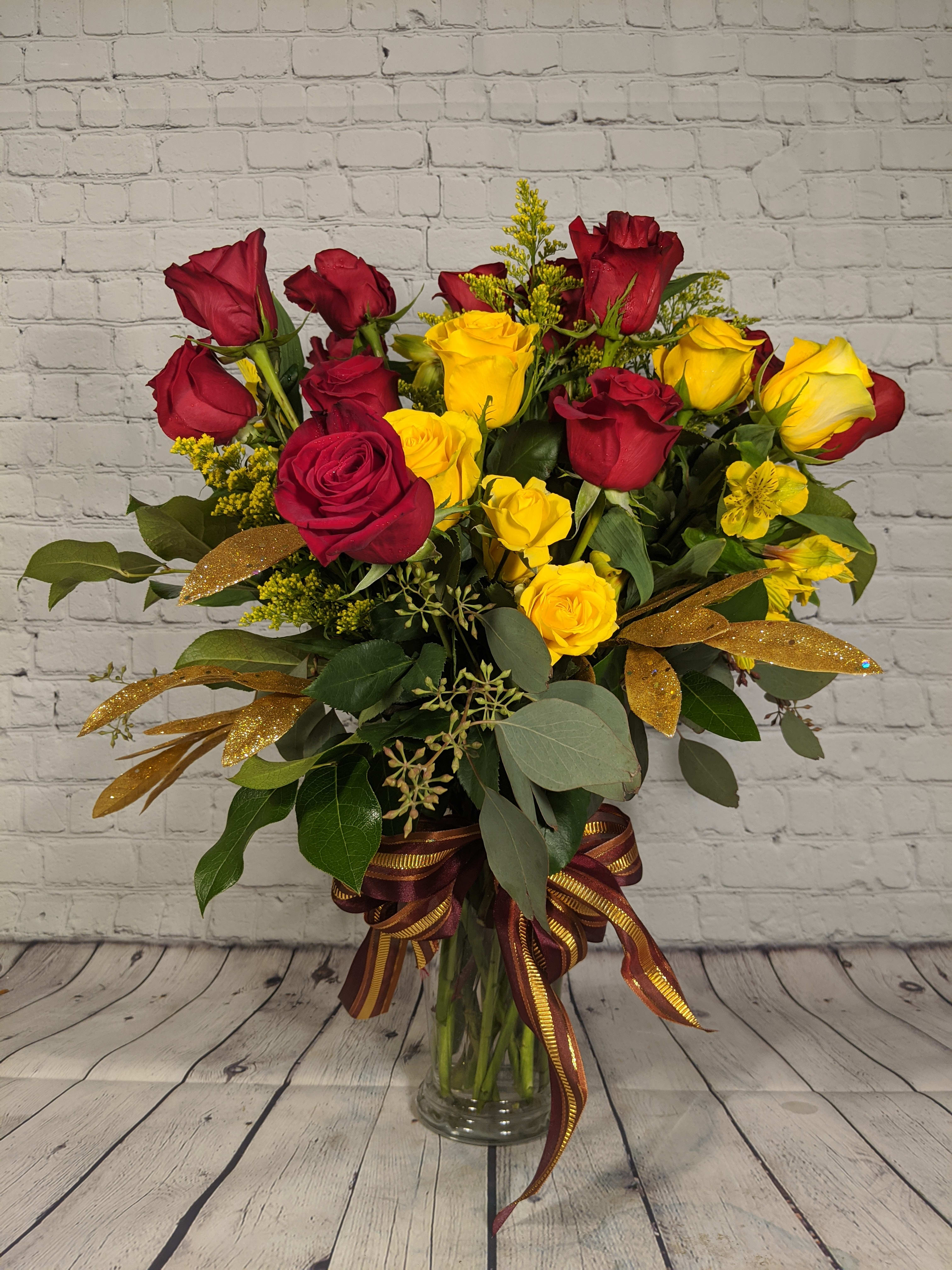 Golden Love - For the one who deserves something extra, send Golden Love. This special bouquet is filled with a dozen Rosa Prima red roses, half a dozen yellow roses, and sparkling golden accents.