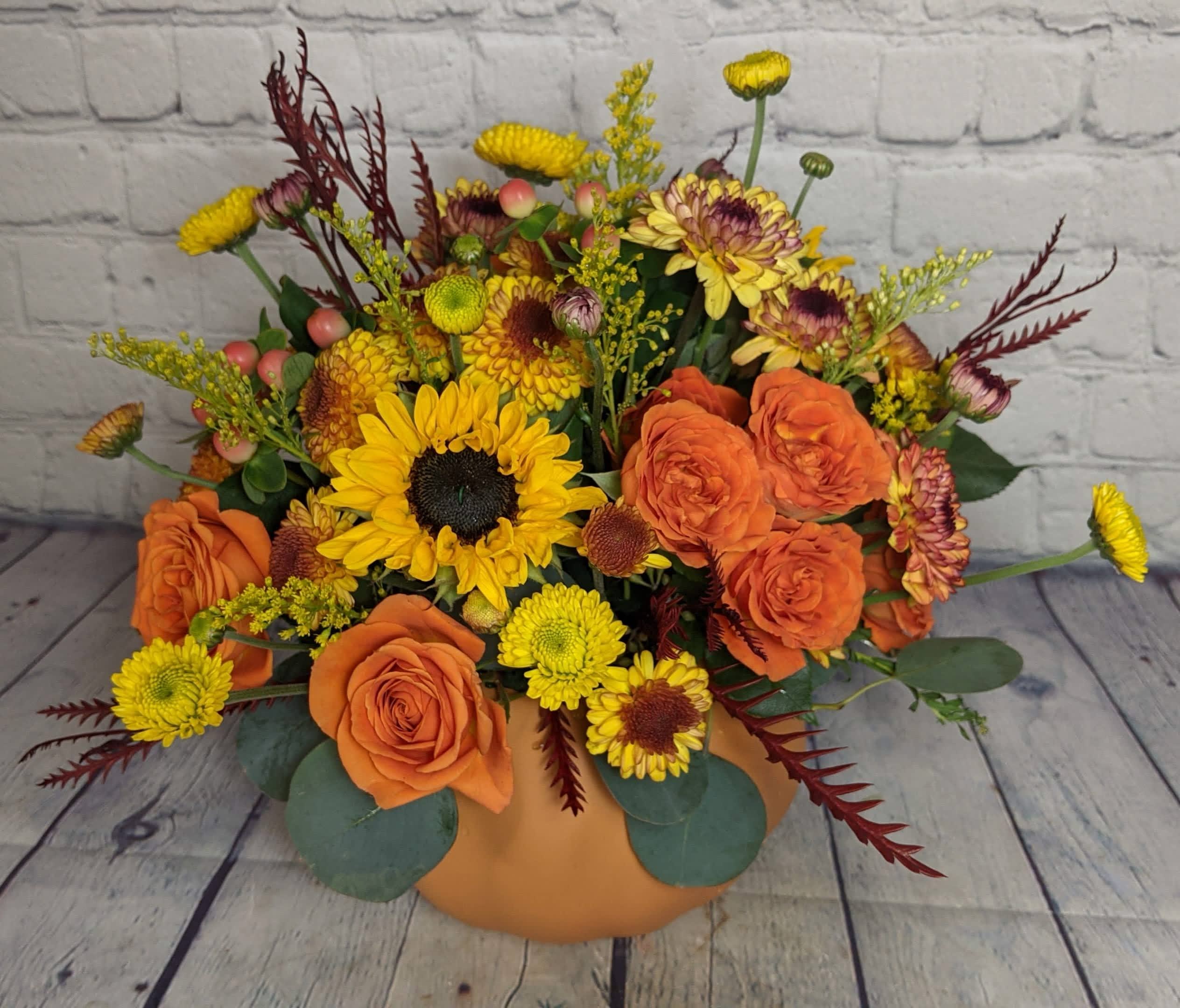 Pumpkin Power - Combine your Flower Power with Pumpkin Power with this wonderful, dare we say “powerful,” seasonal arrangement. Housed in a ceramic pumpkin vase, you will surely “fall” in love with this collection of fall flowers this fall.