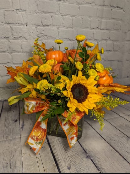 Fall Leaves &amp; Autumn Breeze - This classic autumn bouquet is a bright and delightful way to make someone smile this season. This cube is filled with chrysanthemum buttons, sunflowers, spray roses, alstroemeria, glycerin leaves, and adorable miniature pumpkins. 