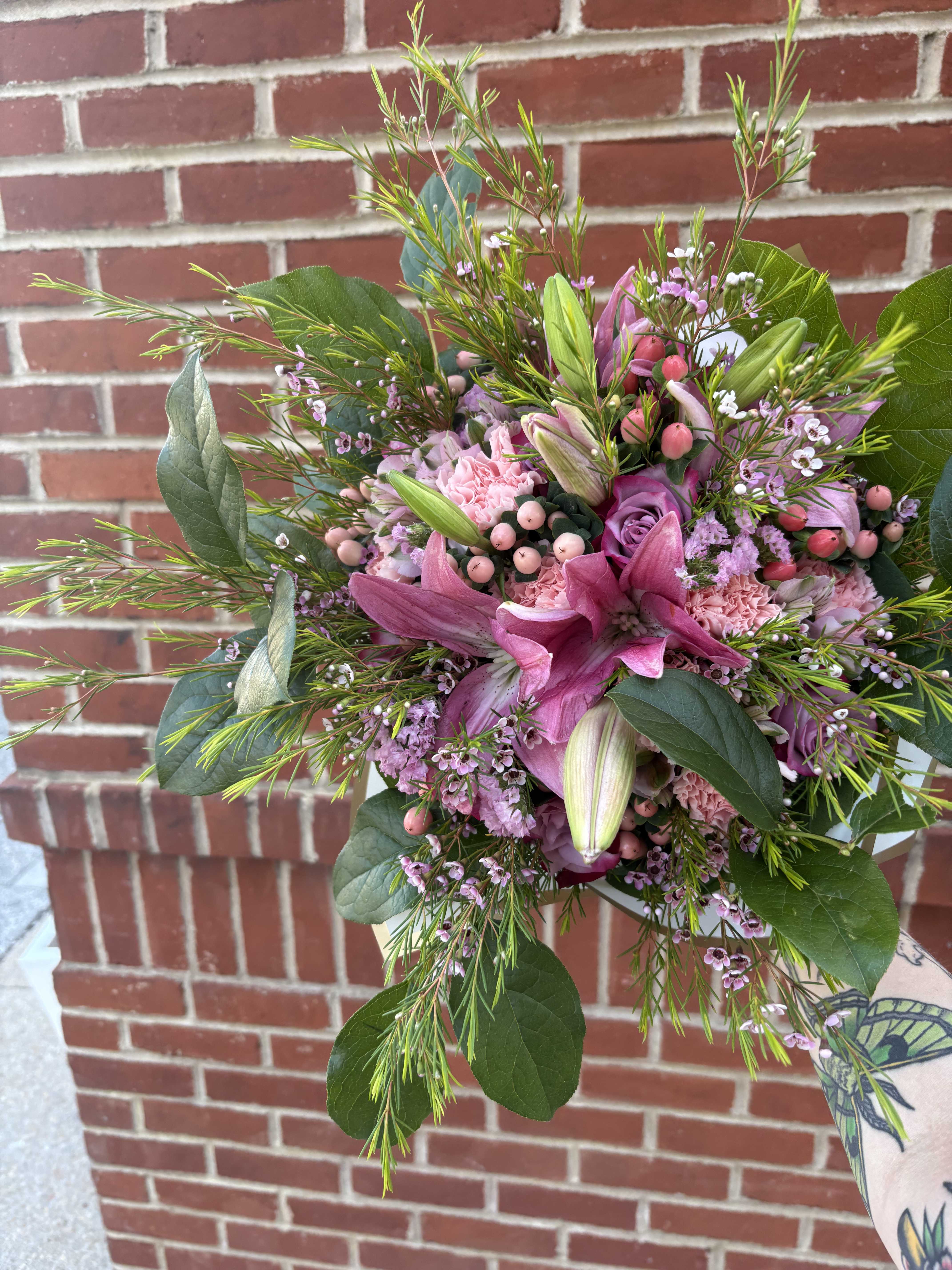 Pink lily and rose bouquet with greenery and small filler flowers