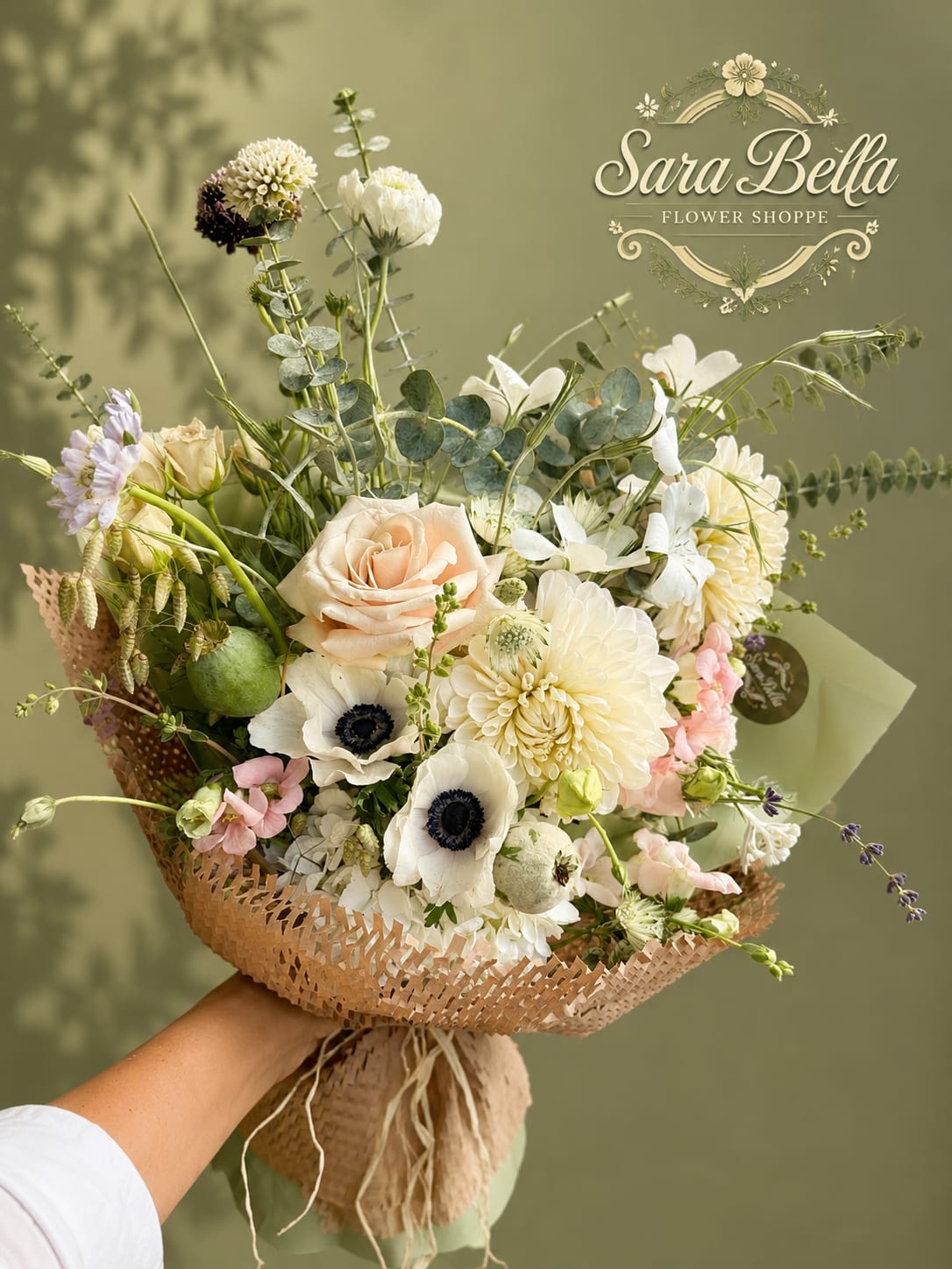 Garden Elegance Bouquet - A lush gathering of creamy roses, white anemones, and seasonal blooms accented with fresh greenery. This airy, garden-style bouquet offers a sophisticated blend of texture, beauty, and natural elegance.